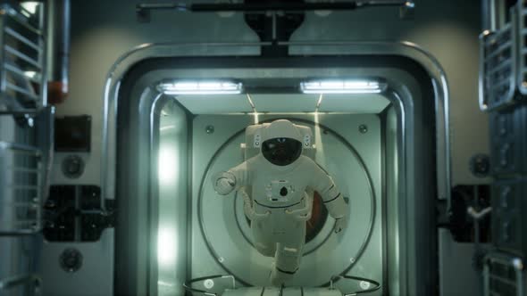 Astronaut Inside the Orbital Space Station alt