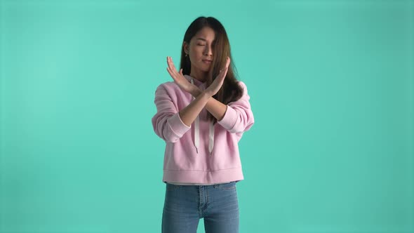 Cute Asian Girl Crossing Arms in X Sign Saying No