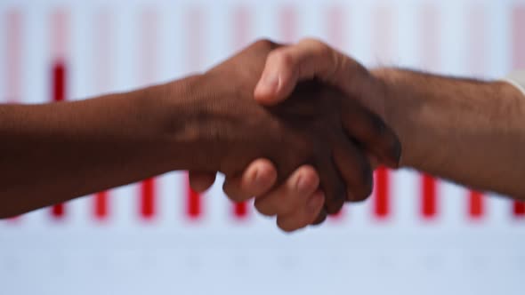 Young businessmen shaking hands in modern office building