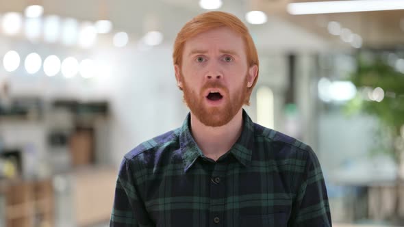 Portrait of Disappointed Beard Redhead Man Reacting To Loss 