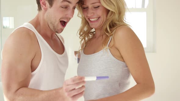 Happy couple discover the pregnancy test