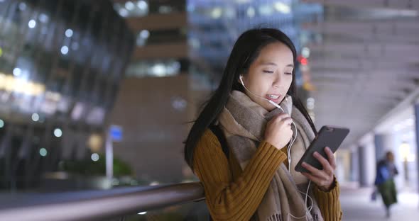 Asian woman use of smart phone at night