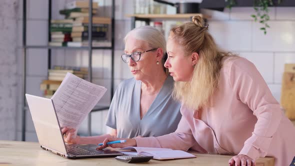 Woman Teaching Mother To Use Internet at Home