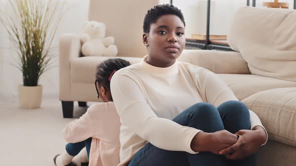 Afro American Offended Mother and Daughter Turned Away From Each Other Sitting on Floor Ignored