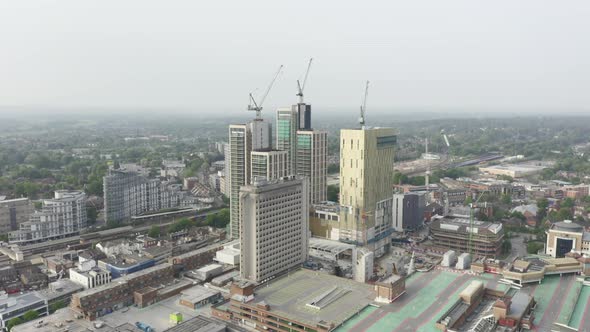 Drone Aerial shot of Woking Cityscape a town in England with high rise skyscrapers and cranes buildi