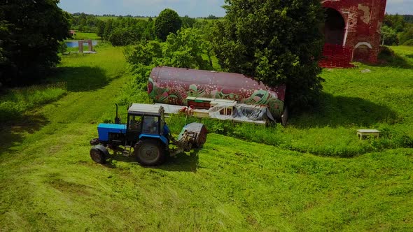 Blue Tractor Works in Nature