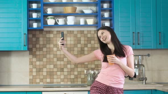 woman drinking morning coffee in kitchen and romantic selfie for Internet