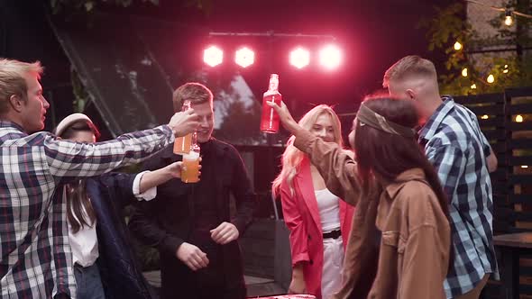 Happy Joyful 30s People Celebrating Their Meeting With Clinking Bottles