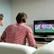 Two young men watching football on television - VideoHive Item for Sale