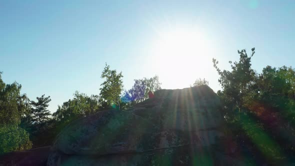 Aerial View of a Girl Doing Fitness and Yoga on a Rock