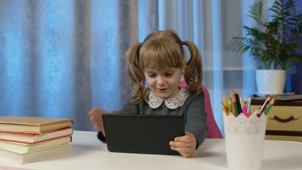 Cute Kid Pupil Watching Video Lesson Studying Using Digital Tablet Computer Doing Homework Online