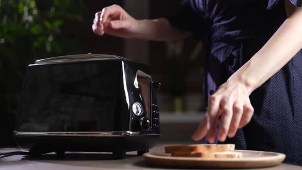 Girl Making Toasts in Retro Toaster