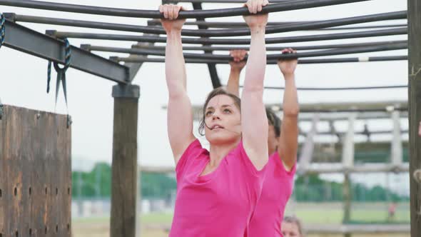 Caucasian and mixed race women exercising at bootcamp