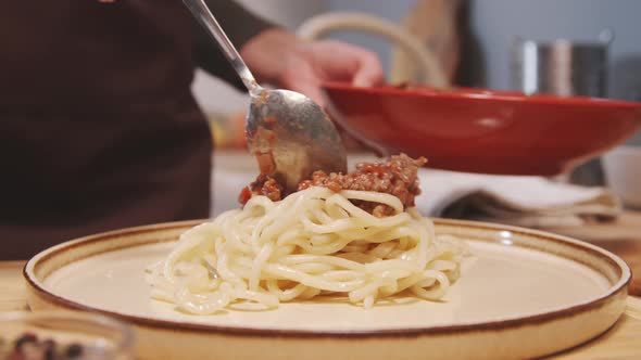 Adding Bolognese Sauce to Spaghetti