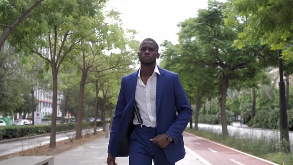 Businessman covering camera with his hand