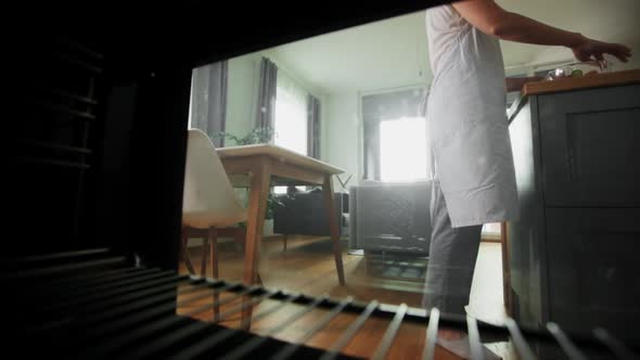 Woman Cooking Food in Oven at Home Kitchen