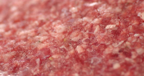 Raw Burger Meat Slowly Rotates. Macro Background. 