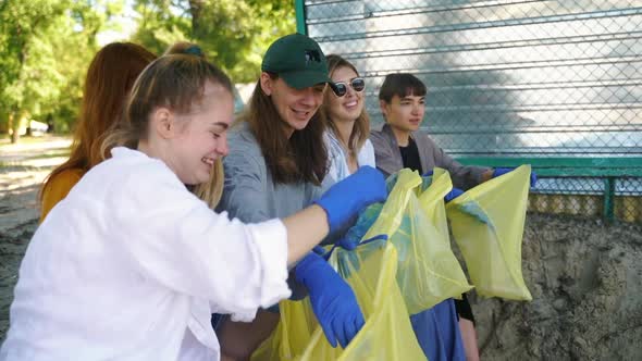 Group of Activists Friends Sort the Garbage Into Bags. Environmental Conservation.