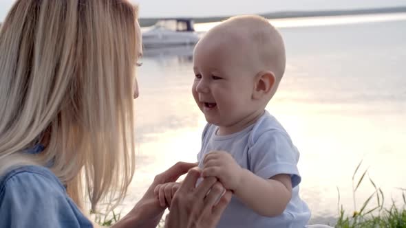 Woman and Baby Boy Relaxing by Lake