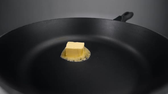 Chef Greases the Hot Pan with Butter, Melting Butter on the Pan, Butter on the End of the Knife