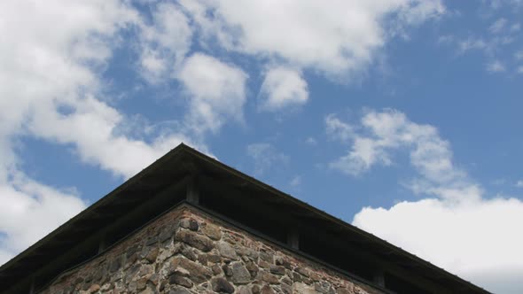 Clouds moving behind watchtower, Auschwitz Birkenau holocaust concept