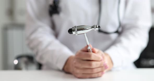 Neurologist Holds Neurological Hammer for Medical Research