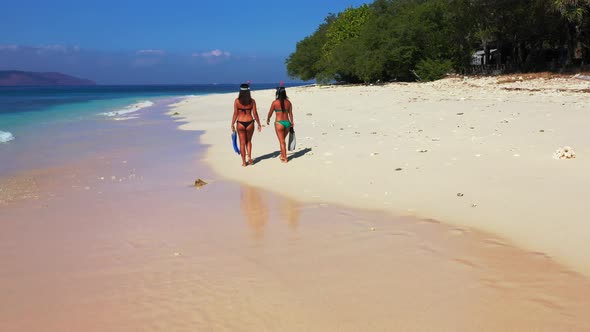 Young beauty models on vacation enjoying life on beach on summer white sand and blue background 4K