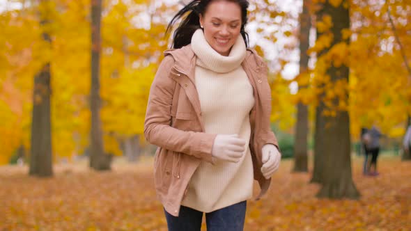 Happy Young Woman Running in Autumn Park 13