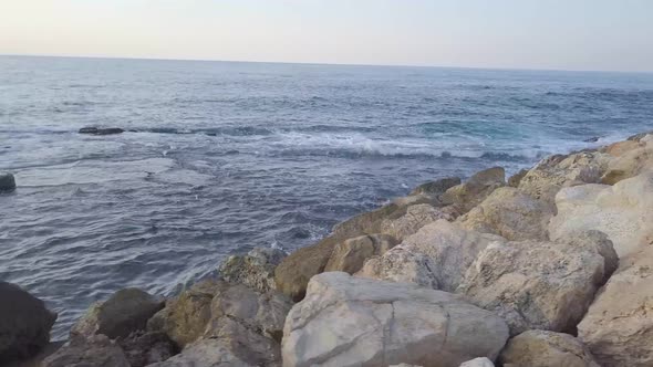 Mesmerizing close up of the rocky breakwater in Jaffa as waves gently lap along the edges