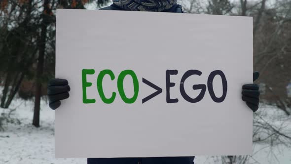 Carrying the banner Eco Ego signifying the danger of a global ecology crisis