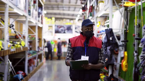 Focused Man Working in Repair Supplies Shop Wearing Mask