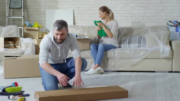 Couple Packing Clothes before Moving