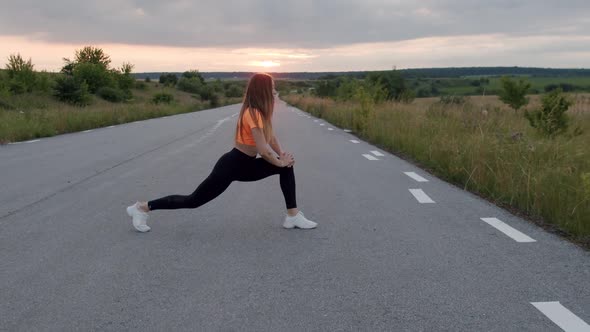 Young Sporty Girl Having Workout on Road at Beautiful Nature on Sunset