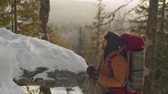 Tourist Enjoying View of Winter Mountains