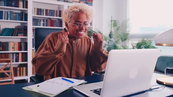 Excited African American Woman Sit at Desk Feel Euphoric Win Online Lottery