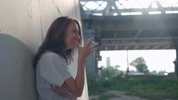 Female Portrait on the Background of a Railway Bridge is Out of Focus