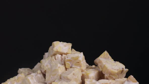 Close Up   Some Raw Cubes Of Tempeh Falling From Above To A Pile Of Tempeh