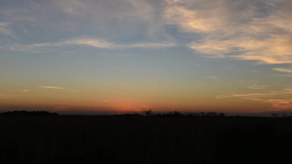 Time lapse shot of the sun dipping behind the horizon as twilight turns to night