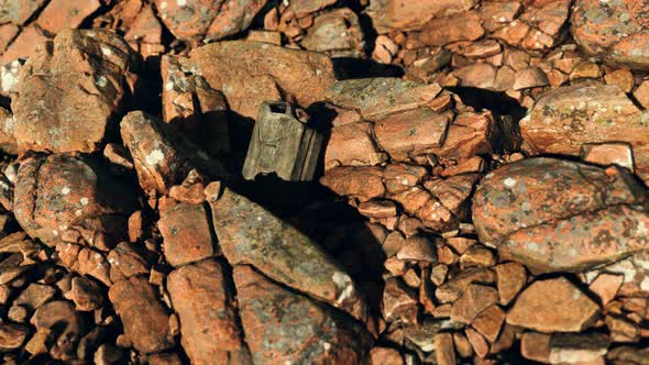 Old Rusty Metal Canister for Gasoline Fuel at Rocks