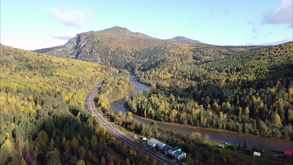 View of the Railway and Mountain River Flowing Along the Forest in the Distance on the Horizon of