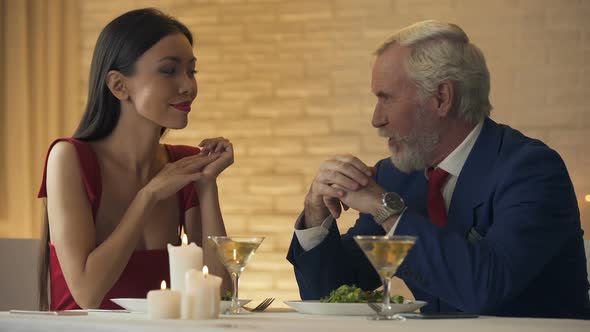 Old Man Inviting Young Girlfriend for Dance, Romantic Evening in Restaurant
