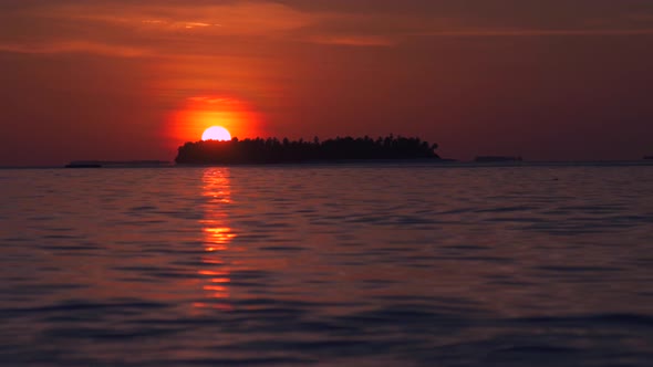 View of a scenic tropical island at sunset in the Maldives.