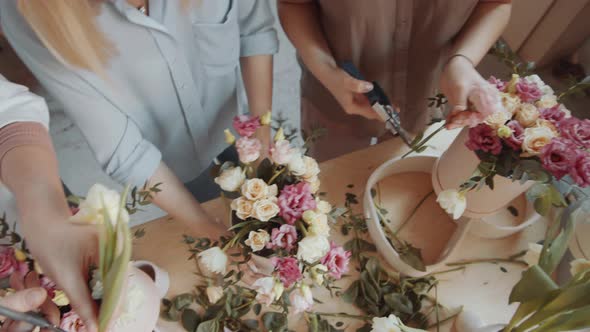 Top View of Hands of Florists Arranging Flower Bouquets