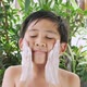 Asian boy is cleaning his face with a foaming cleanser. - VideoHive Item for Sale
