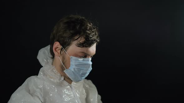 Man in Suit Puts on Mask, Cap on His Hair, Hood and Cap with Foil To Protect Against Radiation From