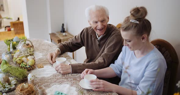 Happy Easter - Grandfather and Granddaughter During Easter Breakfast.