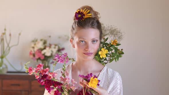 Beautiful blond woman decorated with colorful flowers