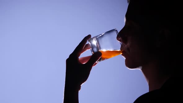 Man Drinking Whiskey. Close Up