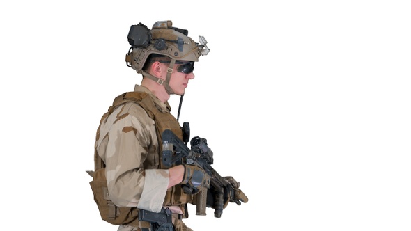 US Army ranger in uniform and weapon walking on white background.