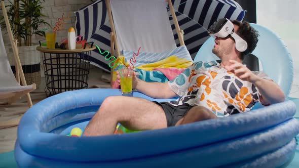 Video of man with VR glasses in an inflatable pool. Shot with RED helium camera in 8K.